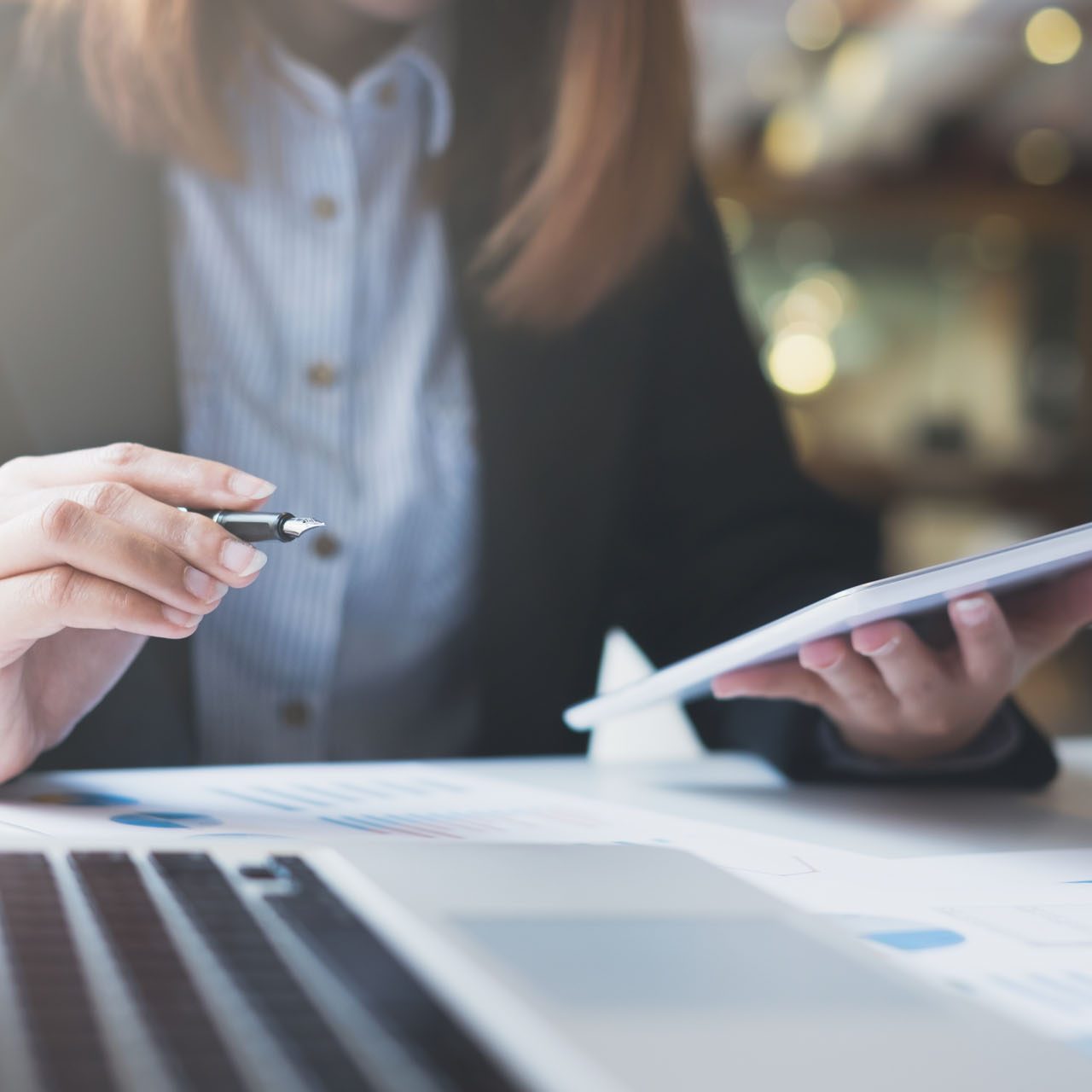 Businesswoman hold pen and works on the digital tablet analyse online infomation.